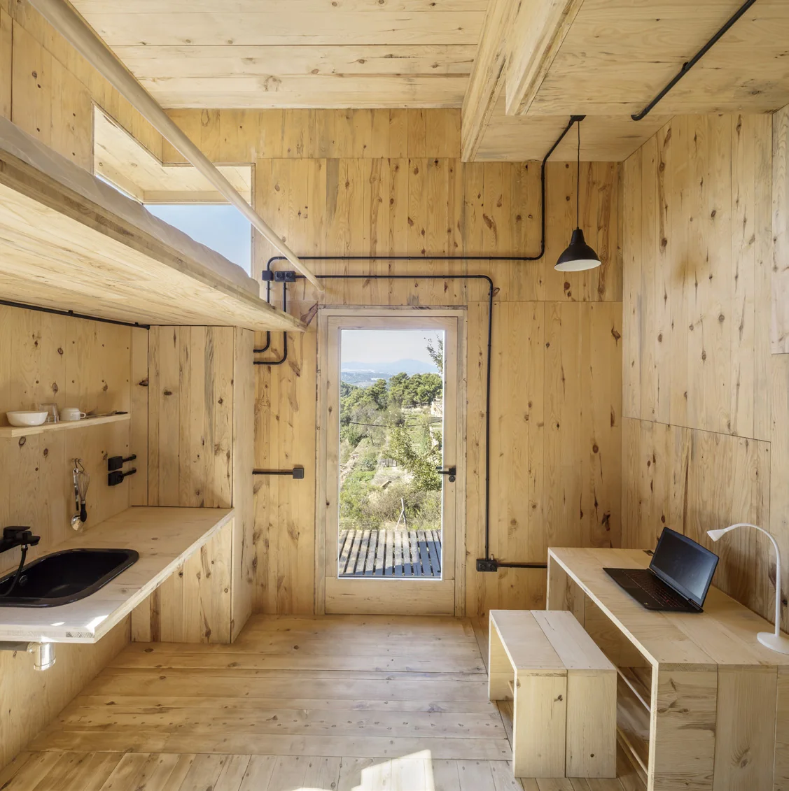 The Voxel interior with a built-in timber desk and shelving in cross-laminated pine