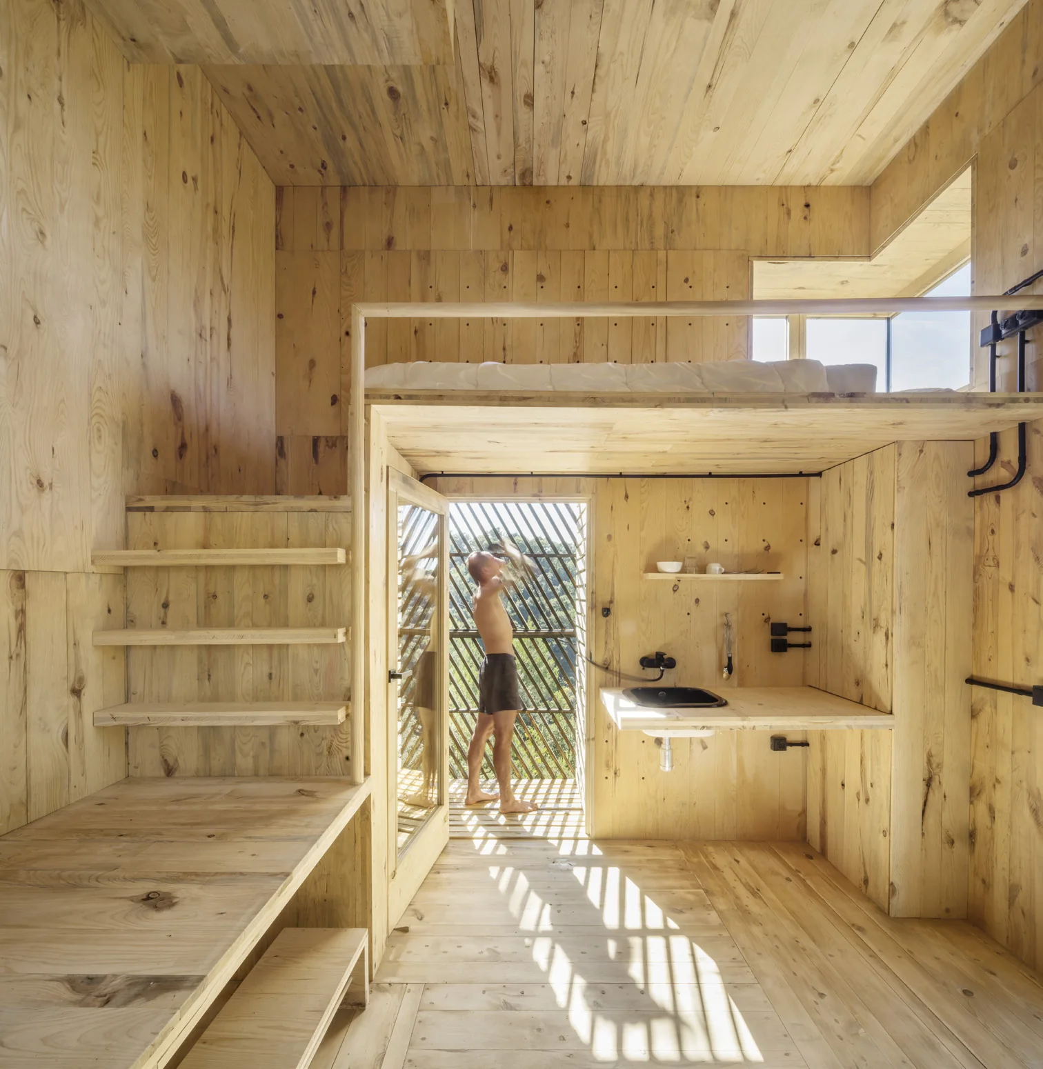 The Voxel interior with a timber loft ladder and built-in storage in cross-laminated pine