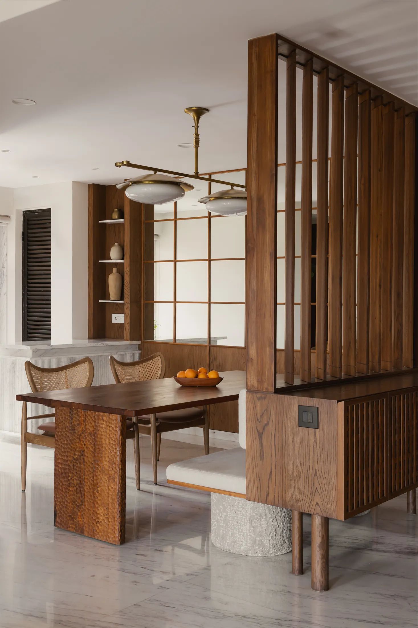 Movable timber louvres between the foyer and dining area of home in•between