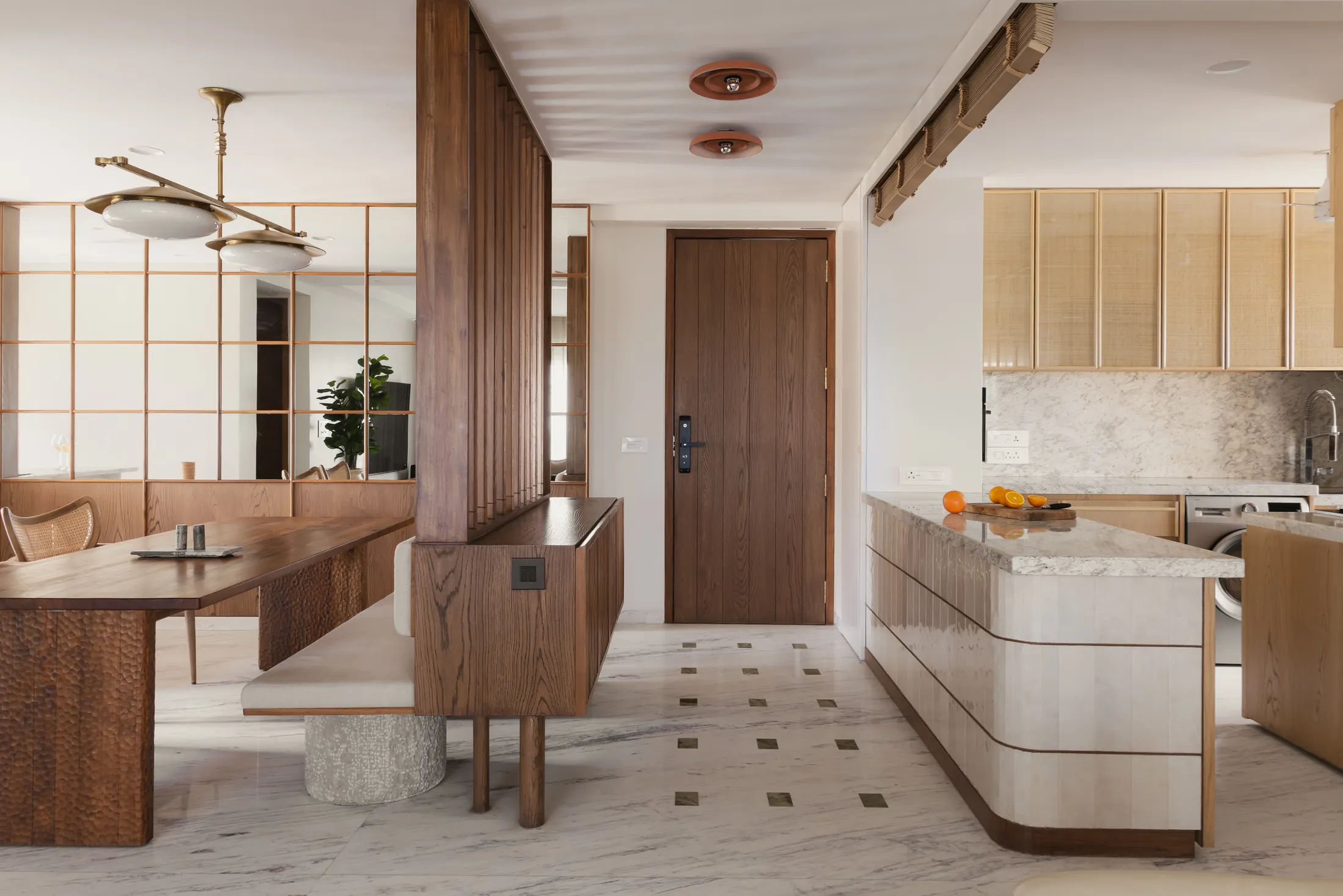Banswara marble floor with inlaid squares leading from the dining area to the kitchen in home in•between