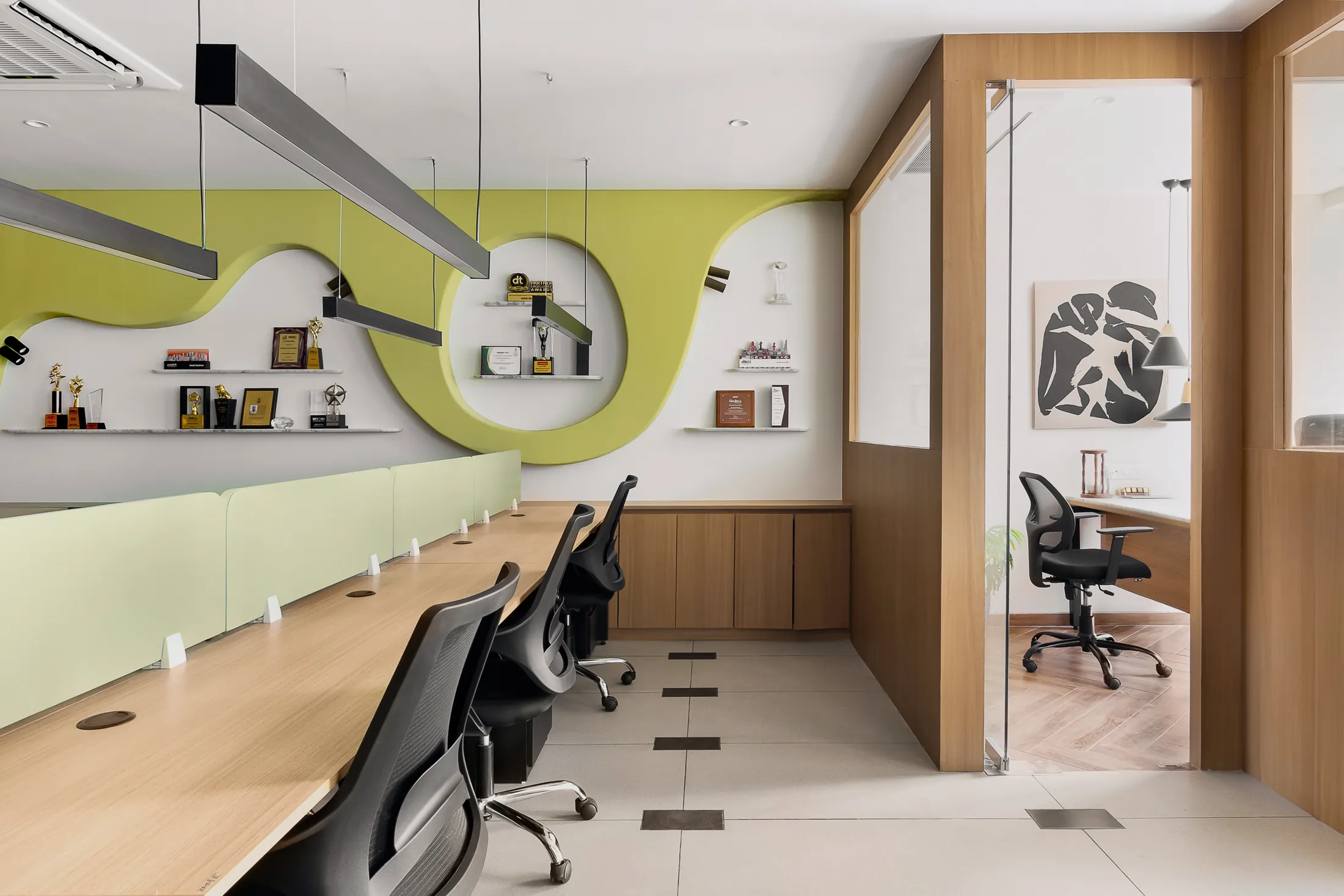Into the Bend open office with a wavy lime-green feature wall, desks and a glass cabin