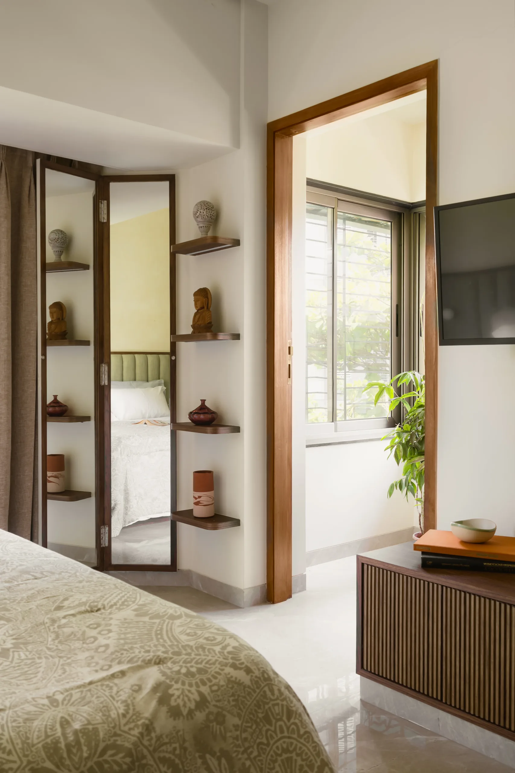 The Nest timber display niches with ceramics beside a bedroom doorway and mirror